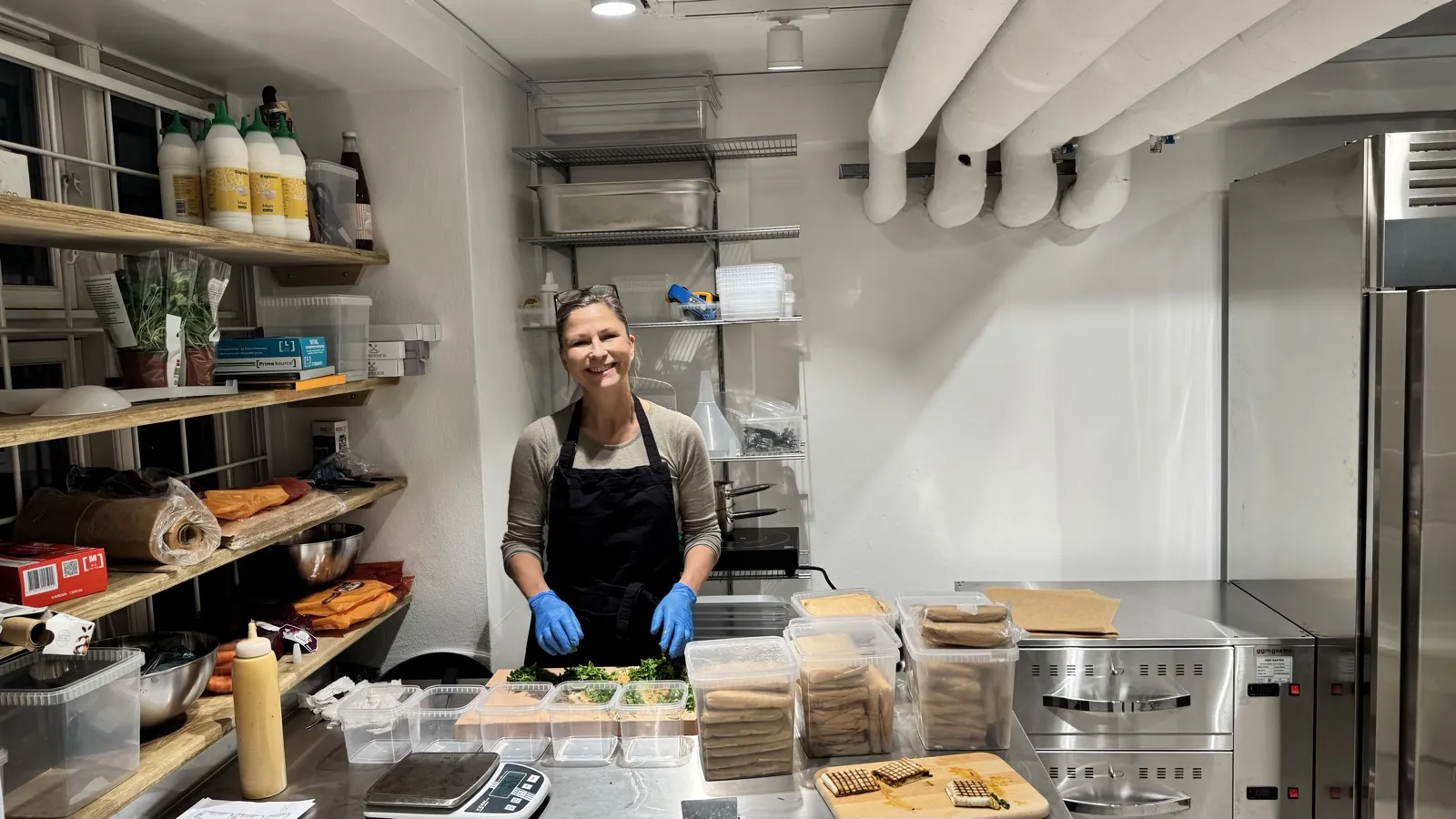 Anne-Marie in the kitchen prepping Sloppy Flatwraps for the opening party